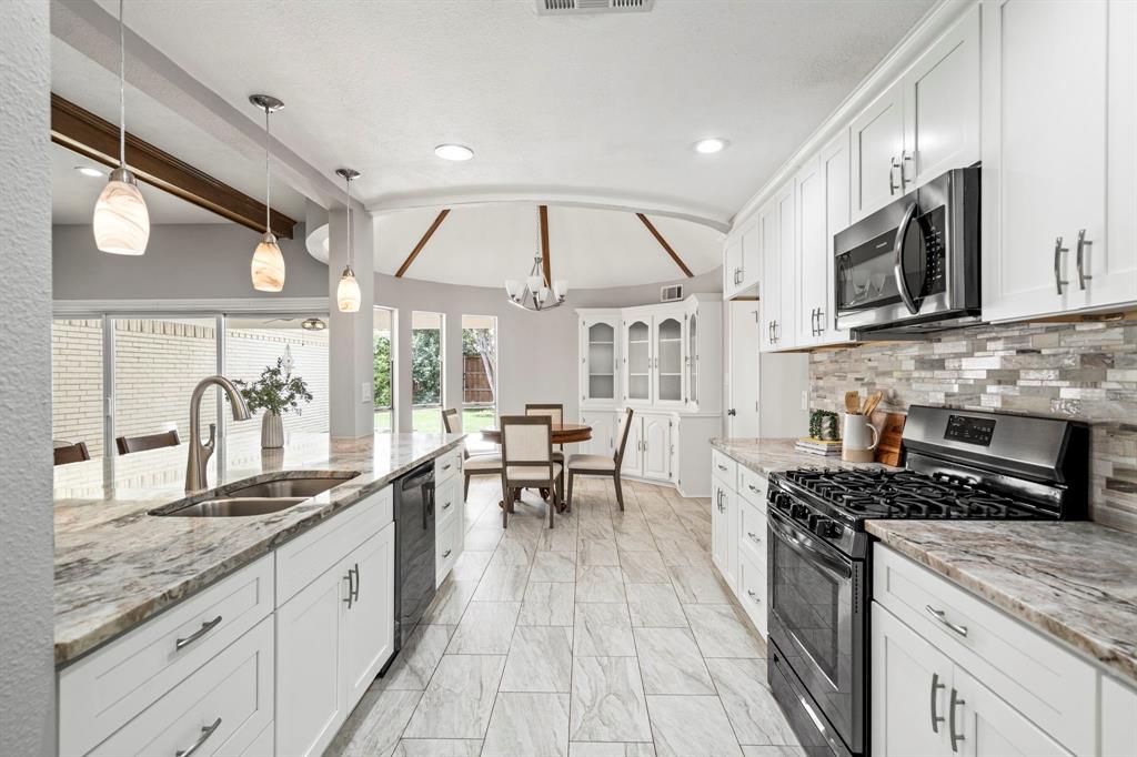 6349 Highgate Lane Dallas, TX 75214 - Photo 14 of 38 a kitchen with stainless steel appliances granite countertop a stove and a sink