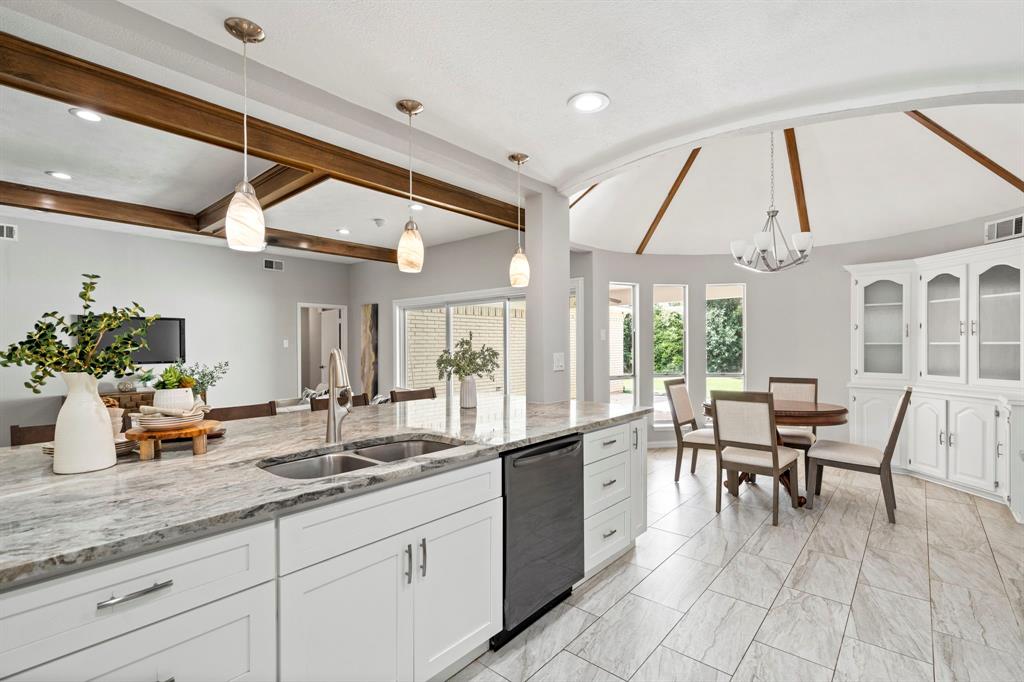6349 Highgate Lane Dallas, TX 75214 - Photo 15 of 38 a dining hall with stainless steel appliances kitchen island granite countertop a table and chairs in it