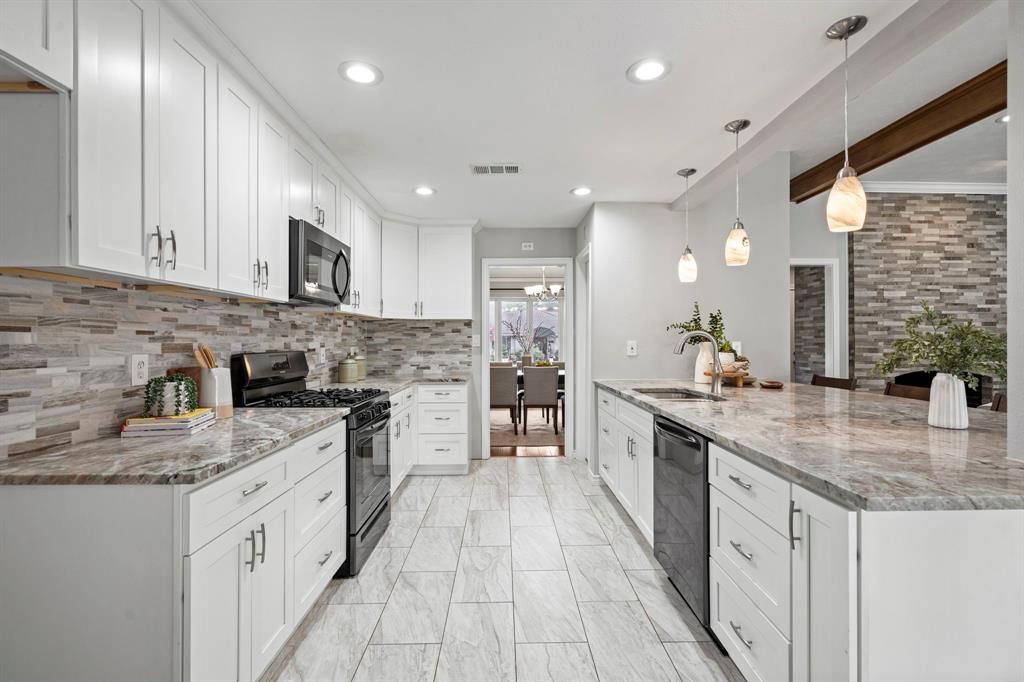 6349 Highgate Lane Dallas, TX 75214 - Photo 16 of 38 a large kitchen with stainless steel appliances granite countertop a stove sink and cabinets