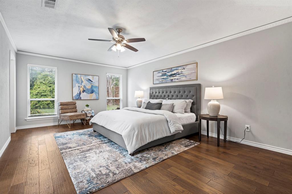 6349 Highgate Lane Dallas, TX 75214 - Photo 23 of 38 a bedroom with a large bed a chandelier and windows