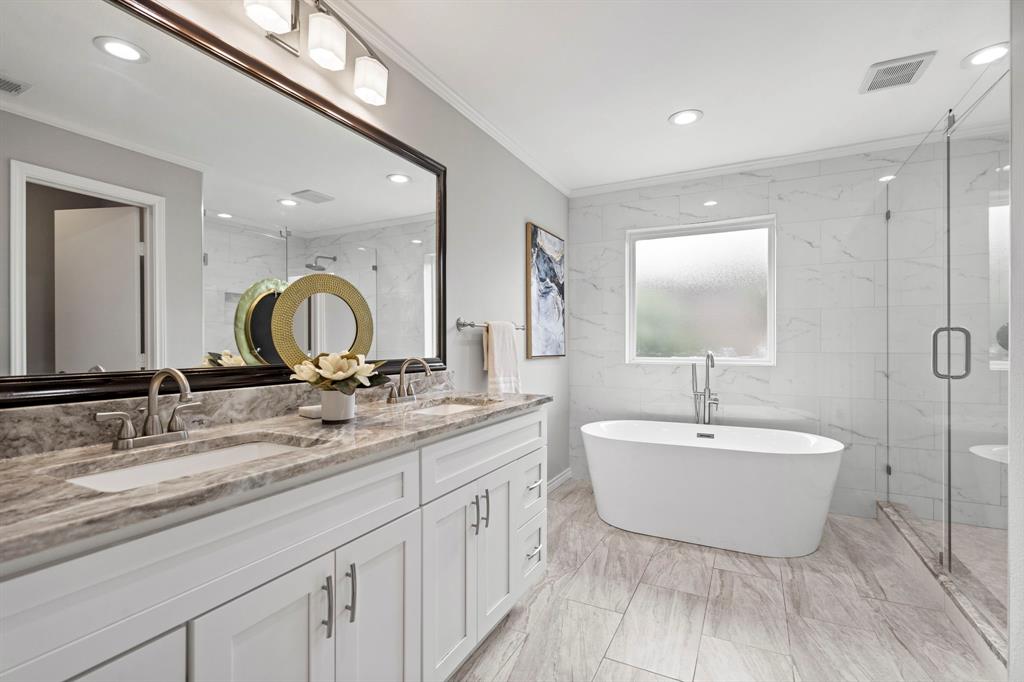 6349 Highgate Lane Dallas, TX 75214 - Photo 25 of 38 a bathroom with a double vanity sink and a mirror