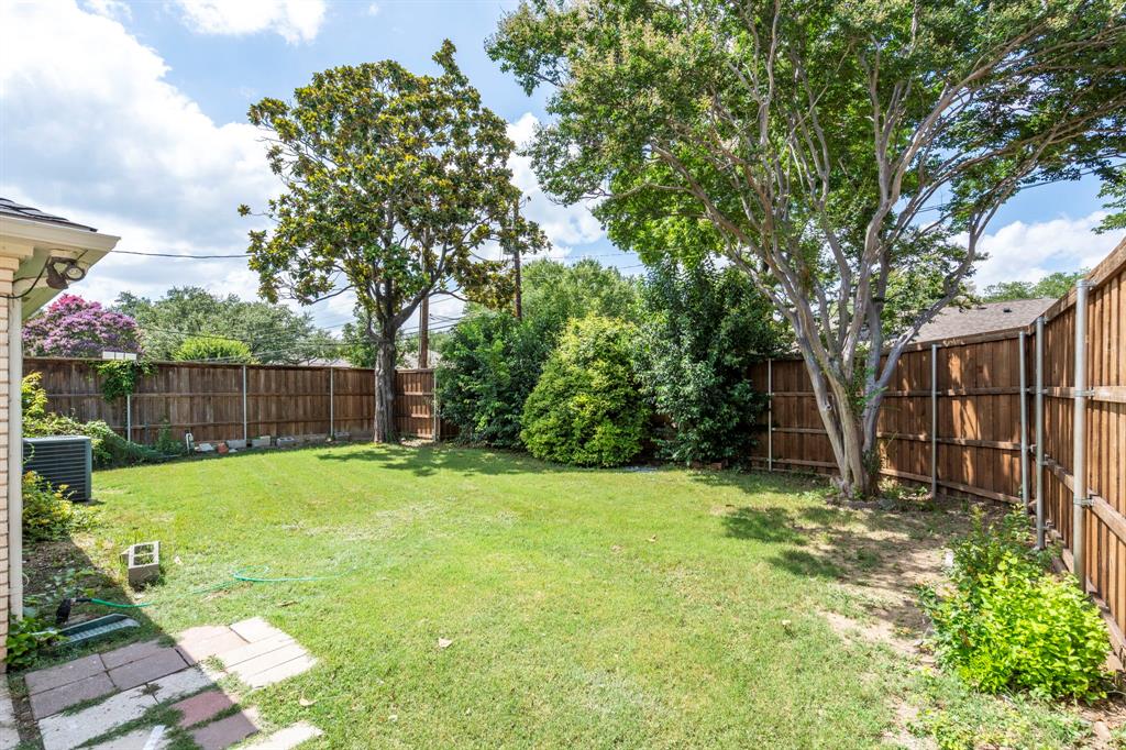 6349 Highgate Lane Dallas, TX 75214 - Photo 38 of 38 a view of a backyard with large trees and wooden fence