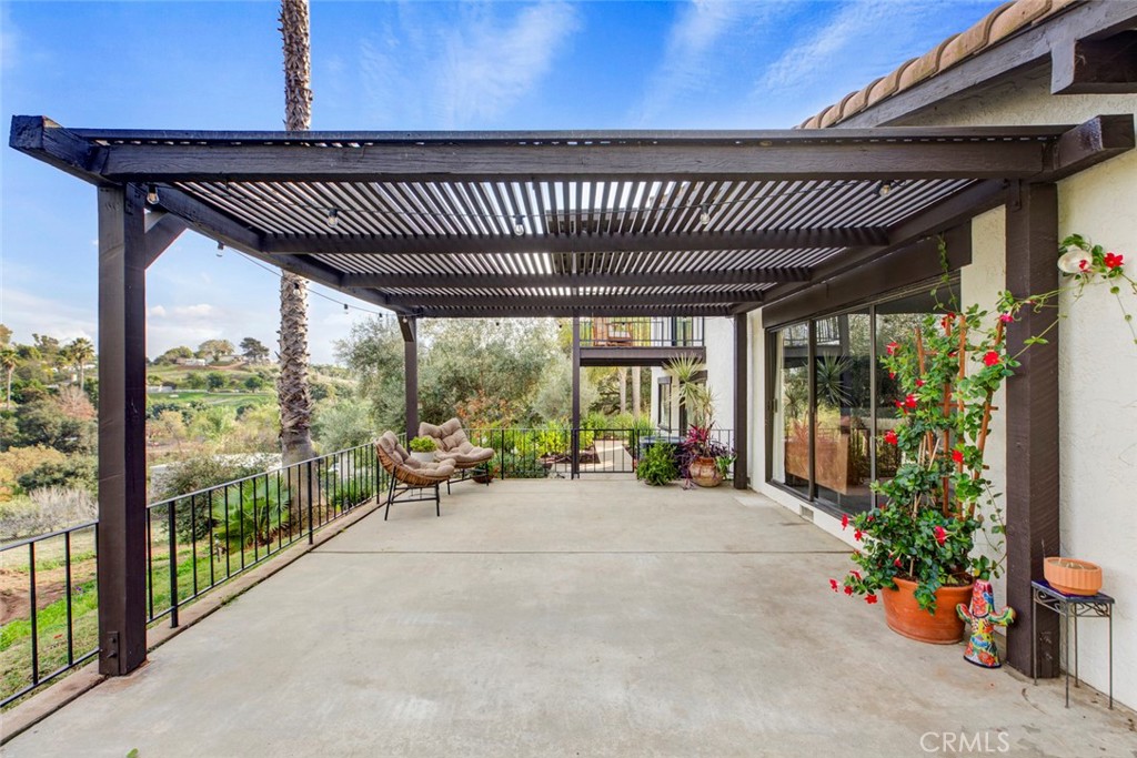2527 Olive Hill Lane Fallbrook, CA 92028 - Photo 11 of 65 a view of a patio with a table and chairs and potted plants