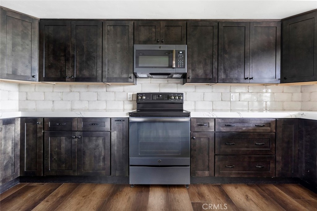 2527 Olive Hill Lane Fallbrook, CA 92028 - Photo 19 of 65 a kitchen with wooden cabinets and a stove top oven