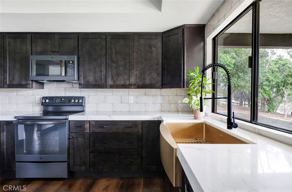 2527 Olive Hill Lane Fallbrook, CA 92028 - Photo 20 of 65 a kitchen with a sink stove and microwave