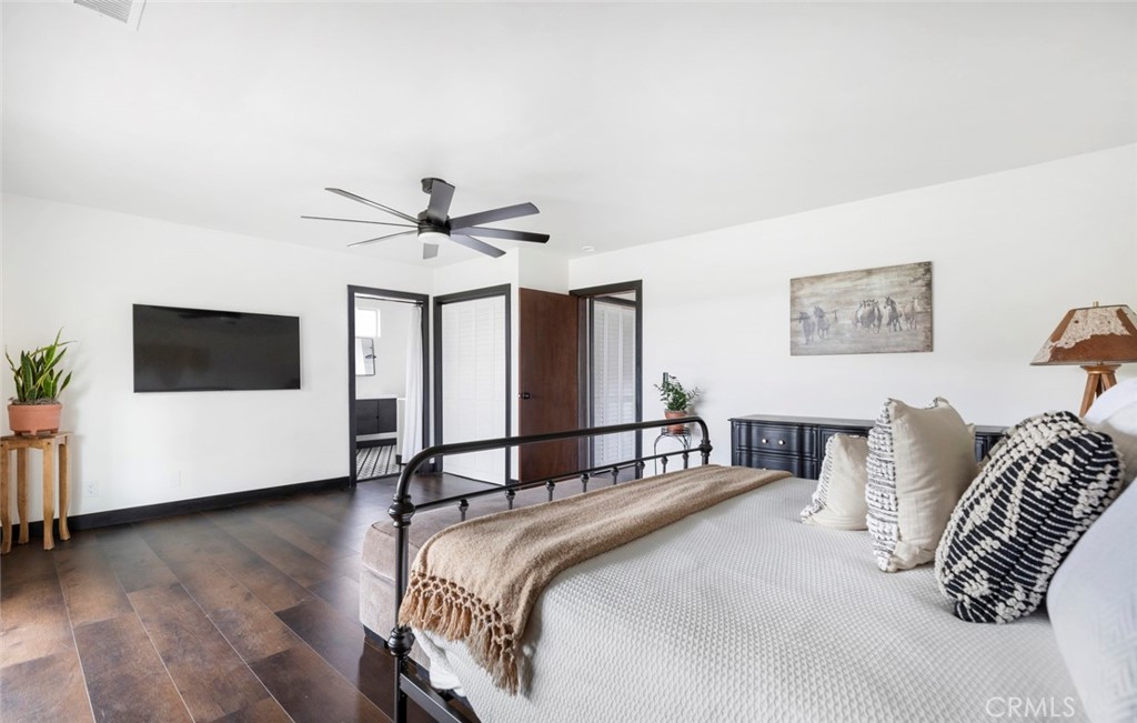 2527 Olive Hill Lane Fallbrook, CA 92028 - Photo 23 of 65 a bedroom with a bed and a chandelier