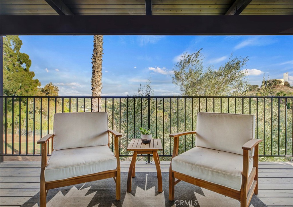 2527 Olive Hill Lane Fallbrook, CA 92028 - Photo 25 of 65 a balcony with wooden floor and outdoor seating
