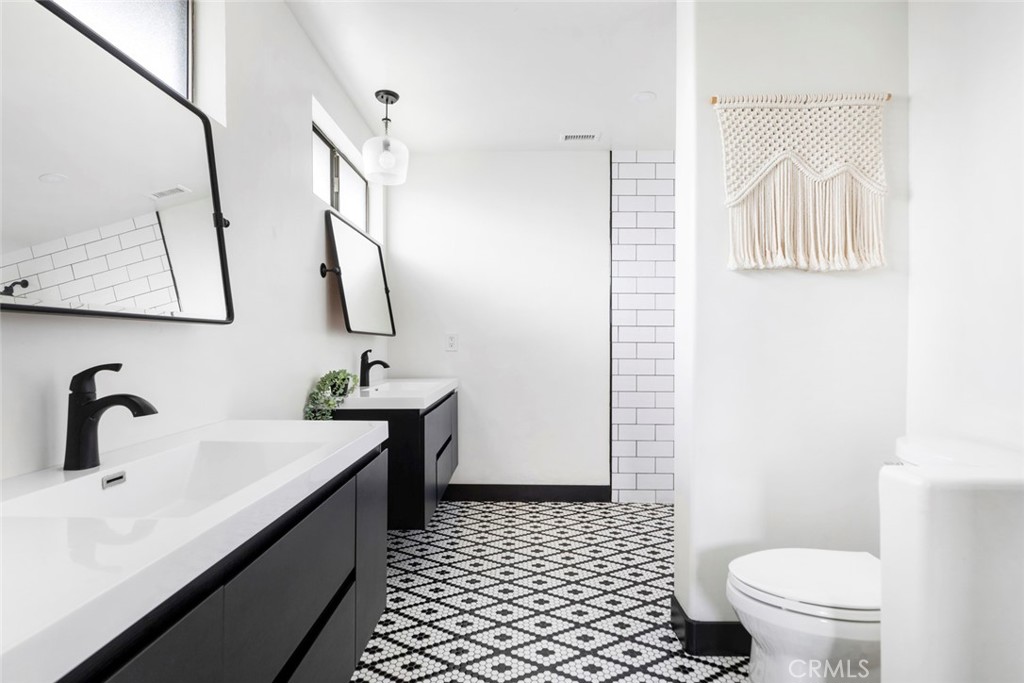 2527 Olive Hill Lane Fallbrook, CA 92028 - Photo 28 of 65 a bathroom with a sink a toilet and a mirror