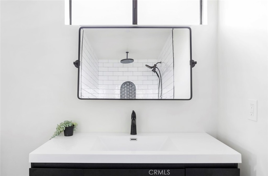 2527 Olive Hill Lane Fallbrook, CA 92028 - Photo 30 of 65 a bathroom with a sink and mirror