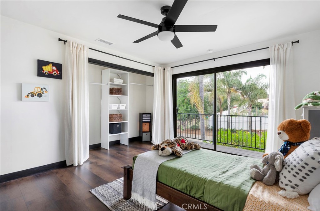 2527 Olive Hill Lane Fallbrook, CA 92028 - Photo 34 of 65 a bedroom with a bed and a large window with the outer view