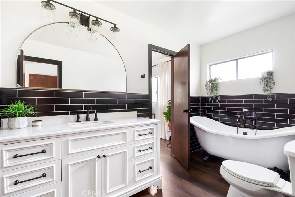2527 Olive Hill Lane Fallbrook, CA 92028 - Photo 43 of 65 a bathroom with a sink a toilet a mirror and shower