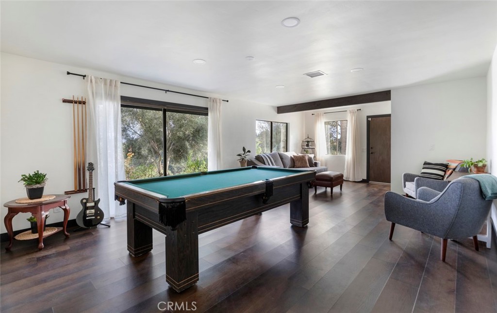 2527 Olive Hill Lane Fallbrook, CA 92028 - Photo 45 of 65 a room with furniture pool table wooden floor and windows
