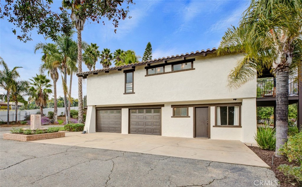 2527 Olive Hill Lane Fallbrook, CA 92028 - Photo 53 of 65 a front view of a house with a yard and garage