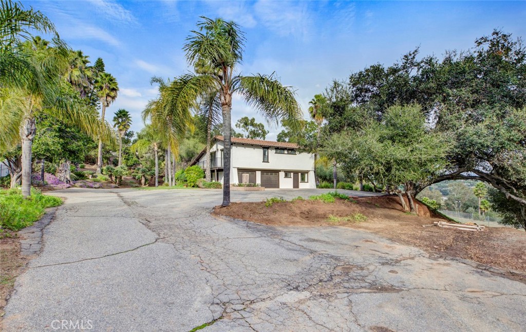 2527 Olive Hill Lane Fallbrook, CA 92028 - Photo 58 of 65 a front view of a house with a yard and garage