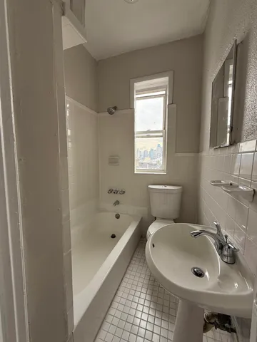 a bathroom with a sink a toilet and bathtub
