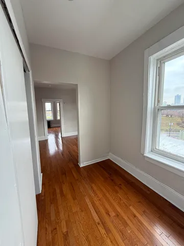 a view of a room with wooden floor staircase and a living room