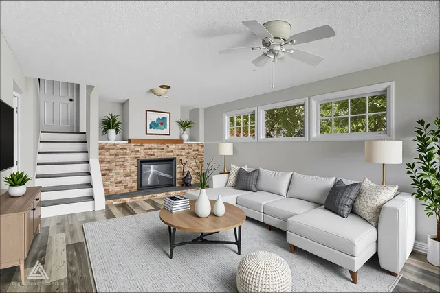 a living room with furniture a fireplace and a chandelier