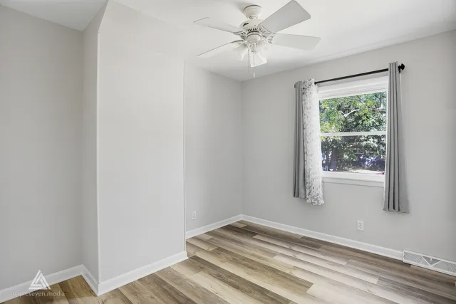a view of room with window and ceiling fan