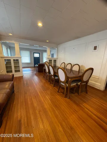 a view of a room with furniture and wooden floor