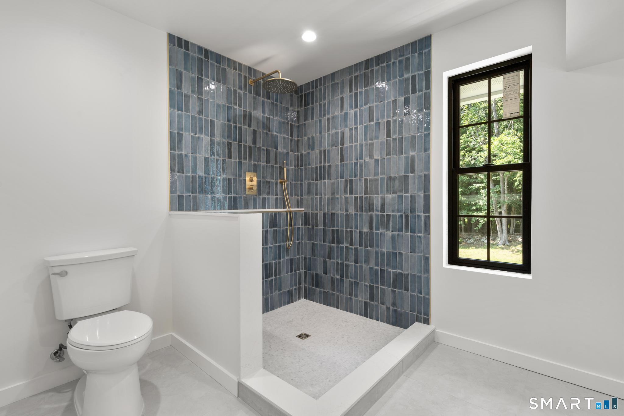 22 Beaver Brook Road Ridgefield, CT 06877 - Photo 21 of 40 a bathroom with a shower and a toilet