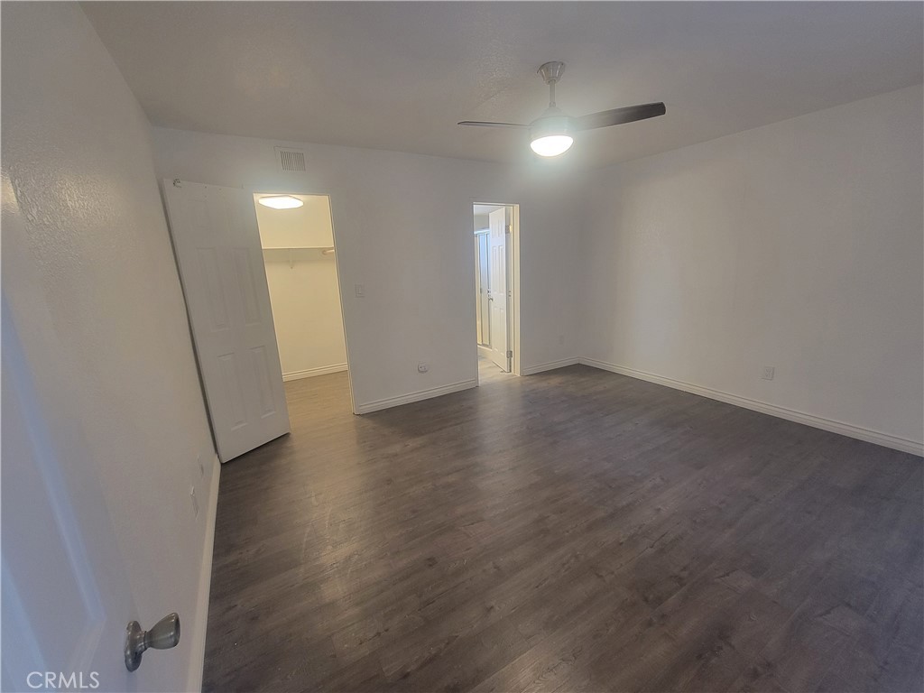 15005 Indiana Paramount, CA 90723 - Photo 3 of 7 an empty room with wooden floor and windows