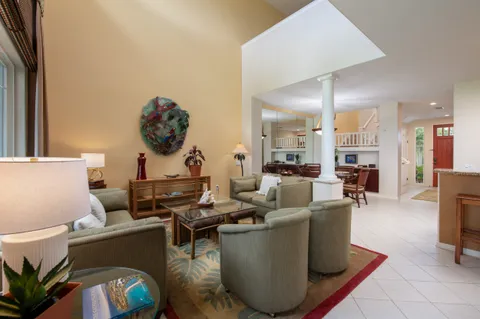 a living room with furniture a table and a painting on the wall