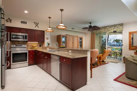 a kitchen with granite countertop a stove and a sink