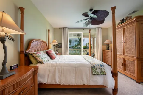 a bedroom with a bed next to a large window with the outer view