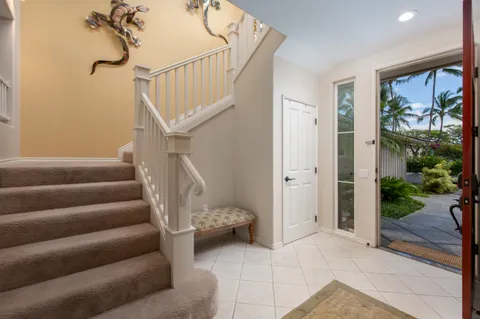a view of entryway bedroom and hall with wooden floor