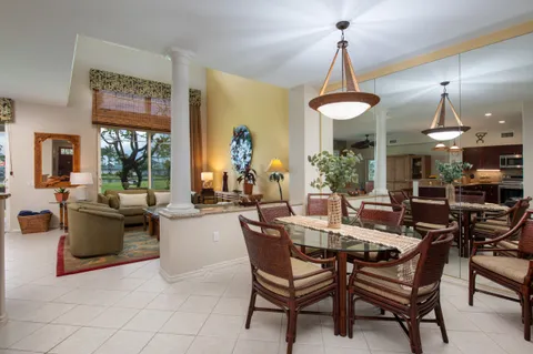 a dining room with furniture a chandelier and window