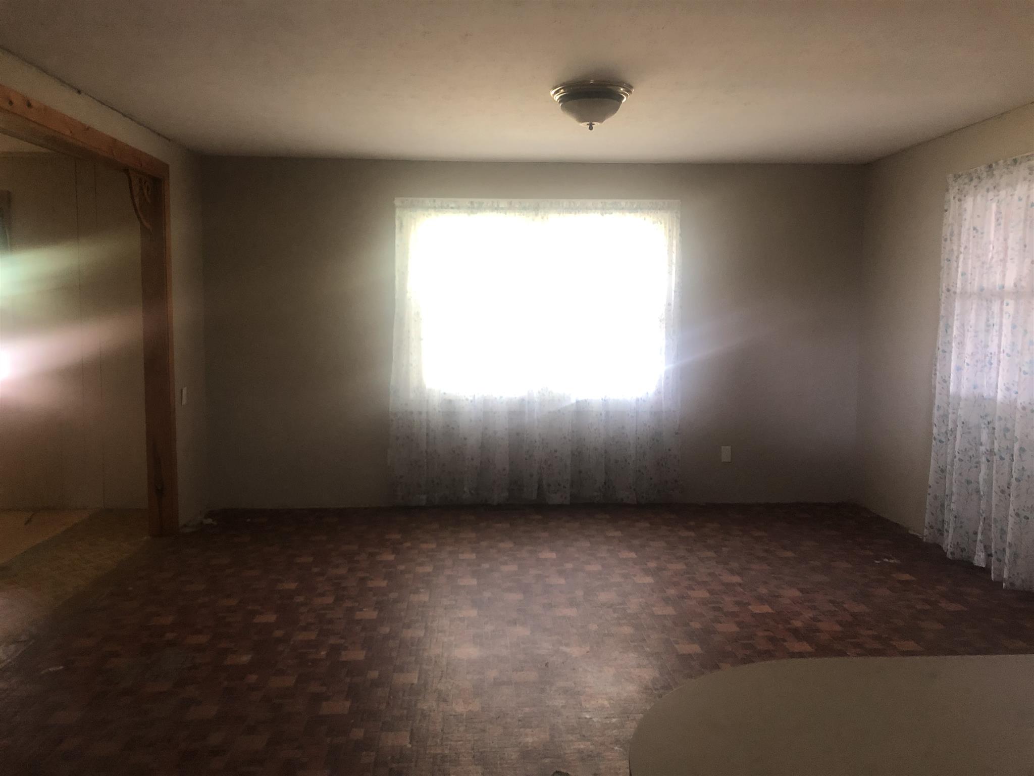4314 Parkhurst Road Red Boiling Springs, TN 37150 - Photo 4 of 8 an empty room with a window and a fan