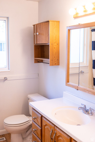 1269 North 400 East, Unit 3 Logan, UT 84341 - Photo 13 of 23 Bathroom featuring a wood-finish vanity with an integrated sink and a framed mirror