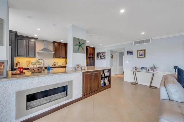 a kitchen with stainless steel appliances kitchen island granite countertop a stove and a sink
