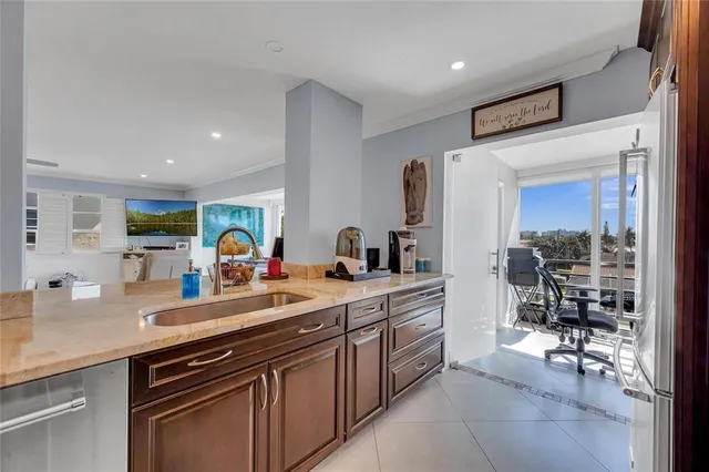 a kitchen with stainless steel appliances a sink stove and cabinets