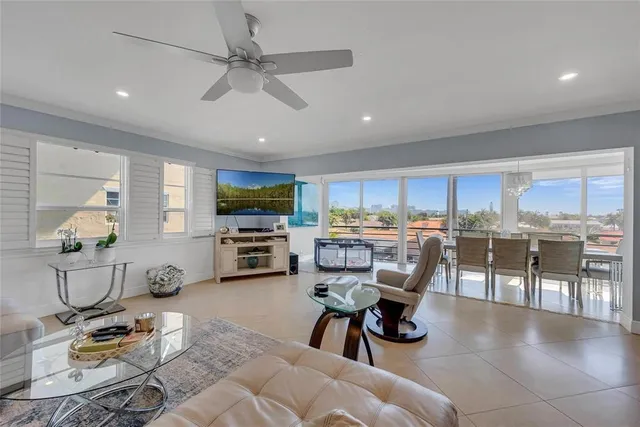 a living room with lots of furniture and kitchen view