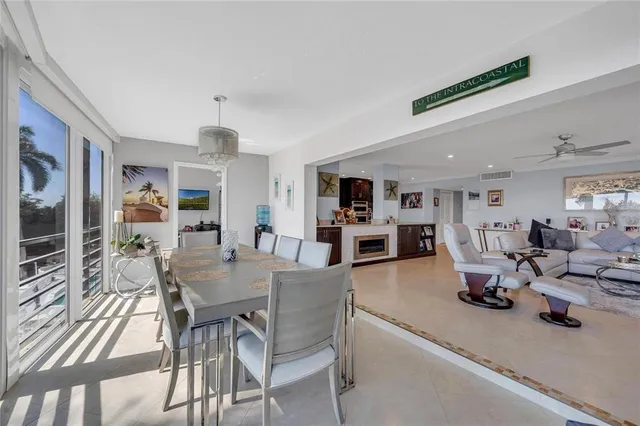 a kitchen with a dining table chairs stove and white cabinets