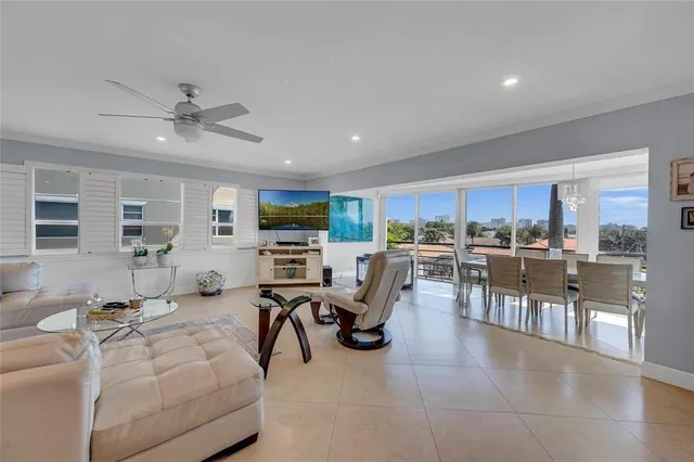 a living room with lots of furniture and view of kitchen