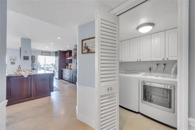 a view of kitchen with stainless steel appliances granite countertop a stove a sink and a refrigerator