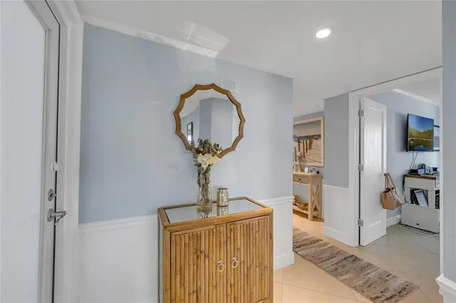 a view of a hallway to a livingroom with furniture