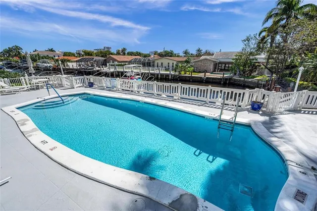 a lake view with boat and palm trees