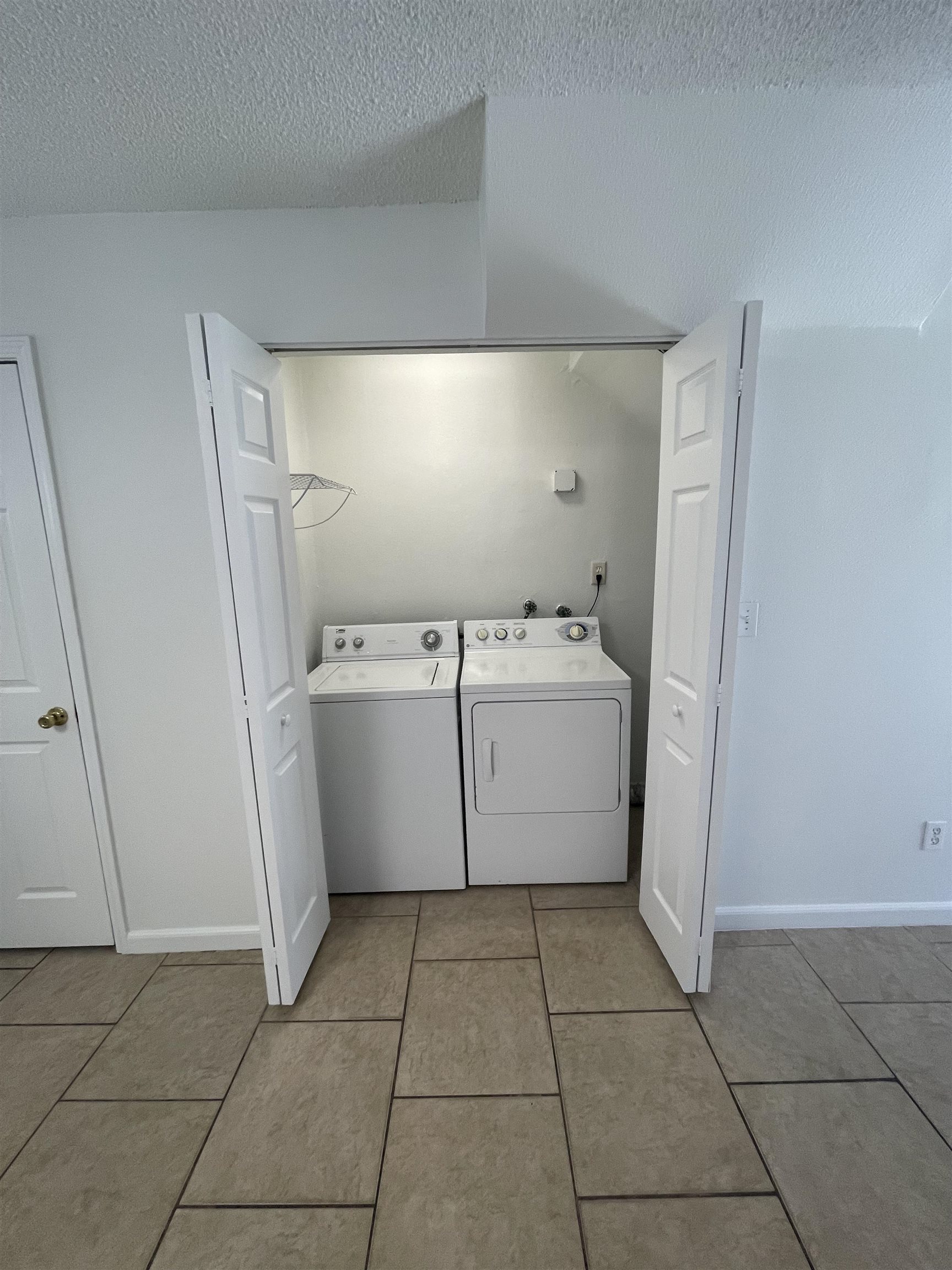 4420 Carter Road, Unit 23 St. Augustine, FL 32086 - Photo 4 of 16 a utility room with cabinets dryer and washer