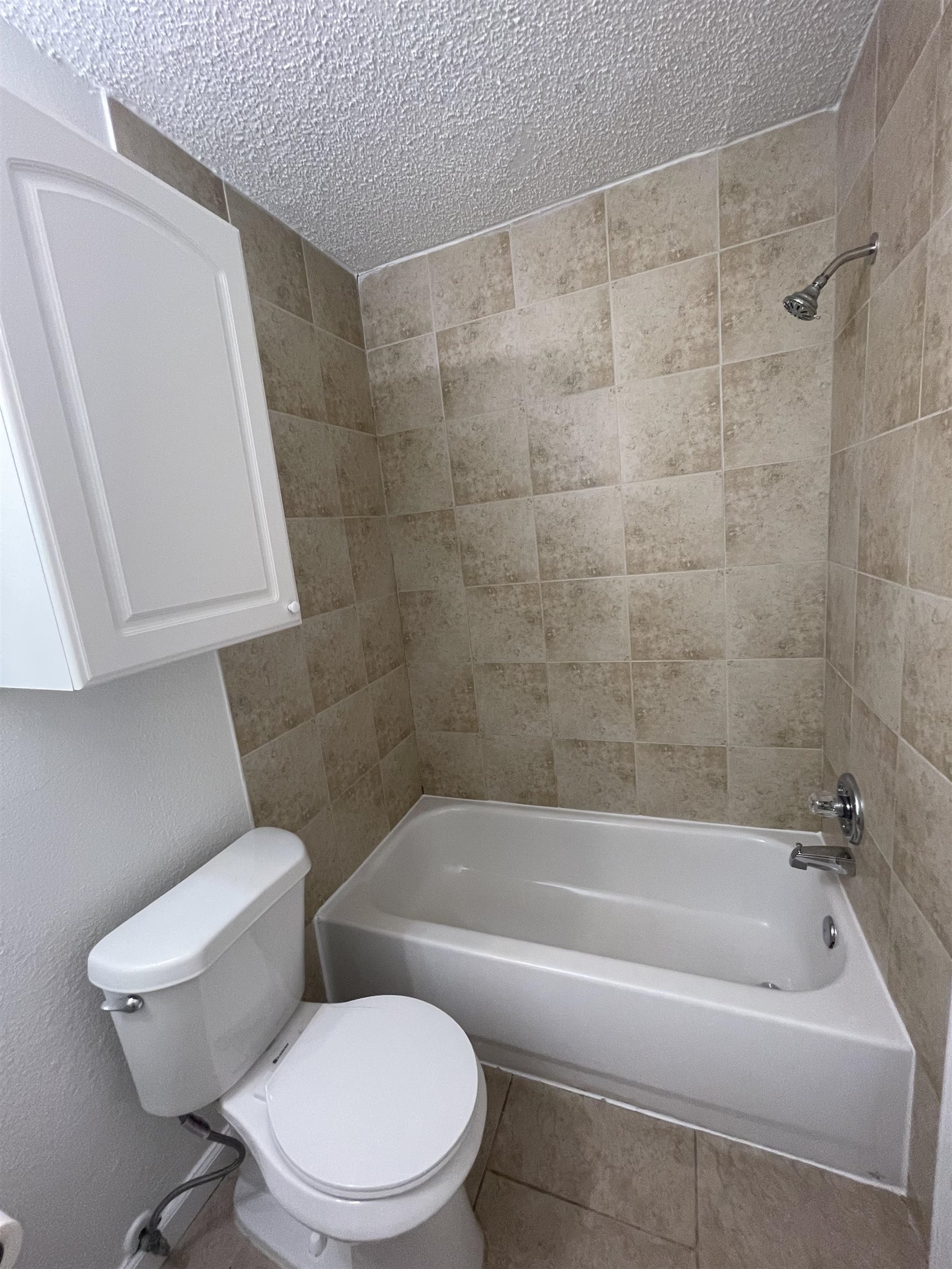 4420 Carter Road, Unit 23 St. Augustine, FL 32086 - Photo 9 of 16 a white toilet sitting next to a bathtub