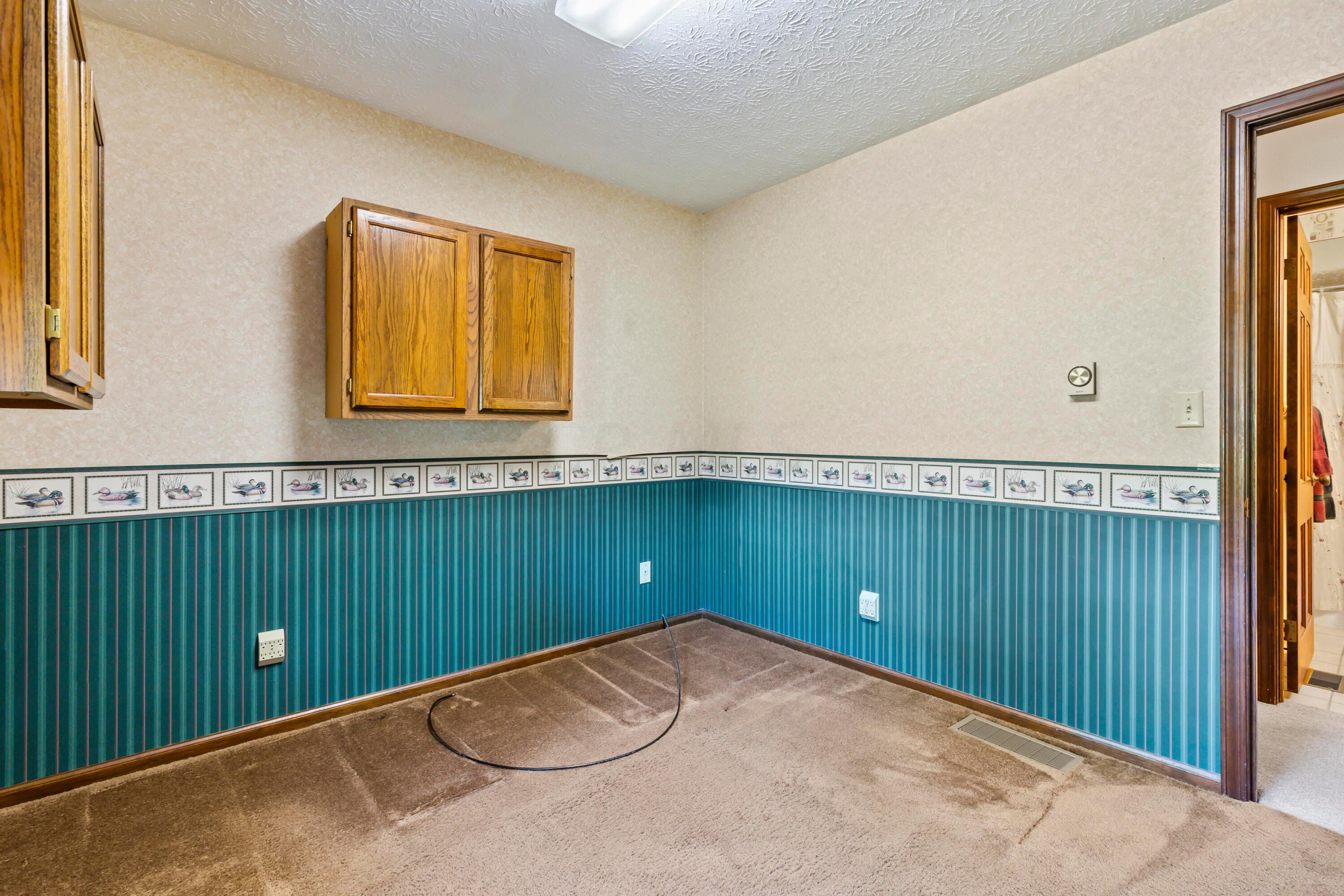 5764 Cheshire Road Galena, OH 43021 - Photo 26 of 59 • Mauve carpet
• Papered walls
• Ceiling light
• Wall cabinets
• Open lighted closet
