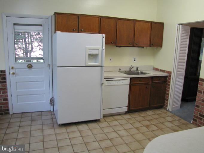 2707 Briggs Road Silver Spring, MD 20906 - Photo 22 of 23 a utility room with cabinets washer and dryer