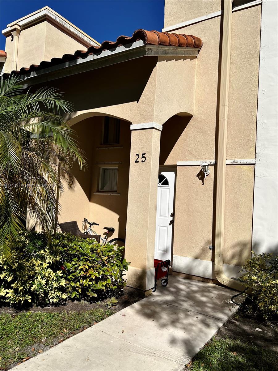 555 Racquet Club Road, Unit 25 Weston, FL 33326 - Photo 2 of 12 a side view of a house with a yard