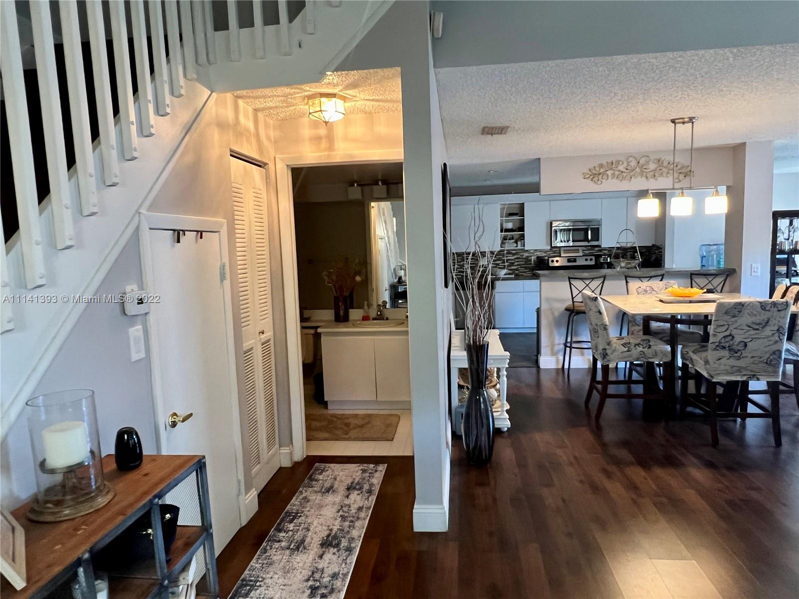 555 Racquet Club Road, Unit 25 Weston, FL 33326 - Photo 3 of 12 a view of a dining room with furniture window and wooden floor