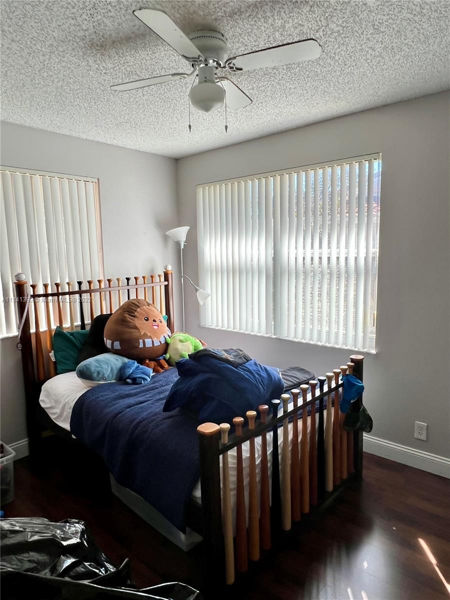 555 Racquet Club Road, Unit 25 Weston, FL 33326 - Photo 8 of 12 a bedroom with a bed and a window