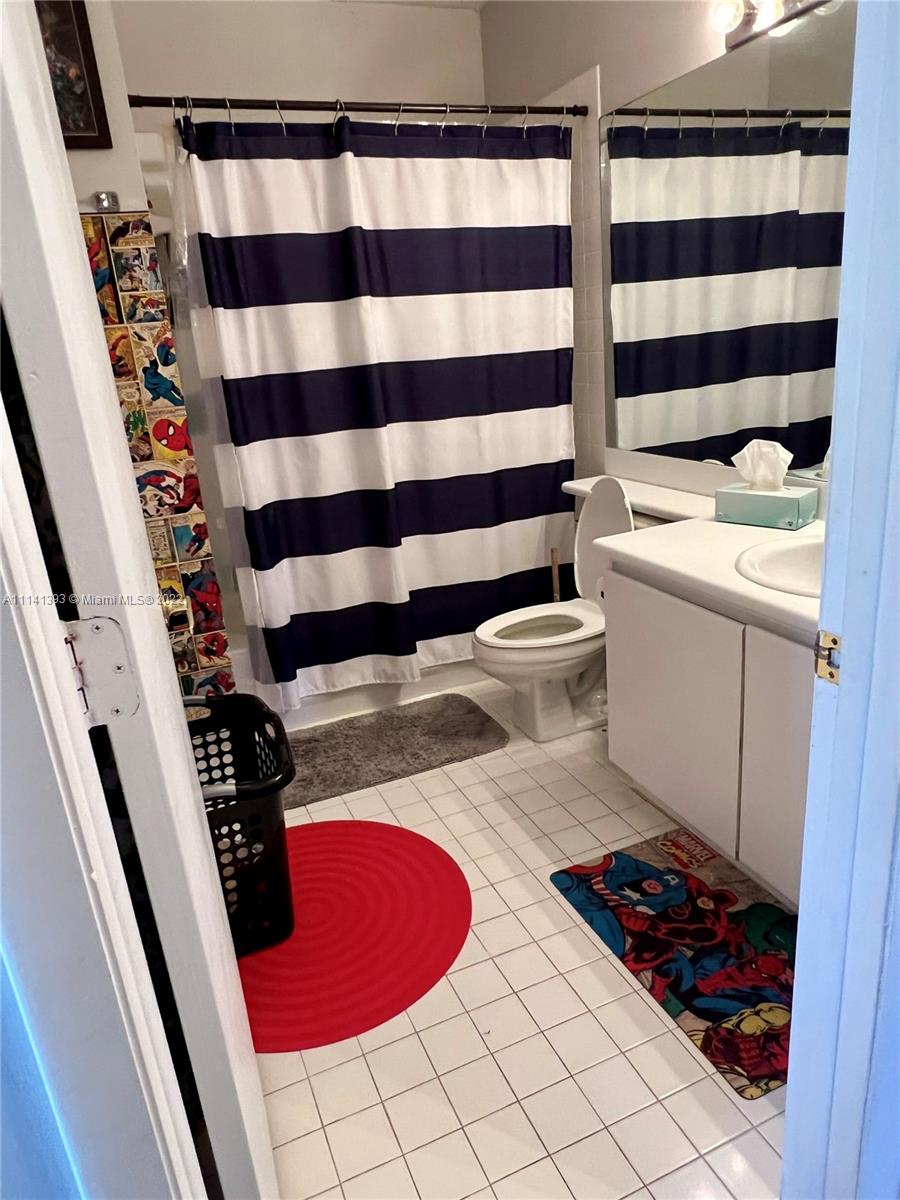 555 Racquet Club Road, Unit 25 Weston, FL 33326 - Photo 10 of 12 a bathroom with a sink and a mirror