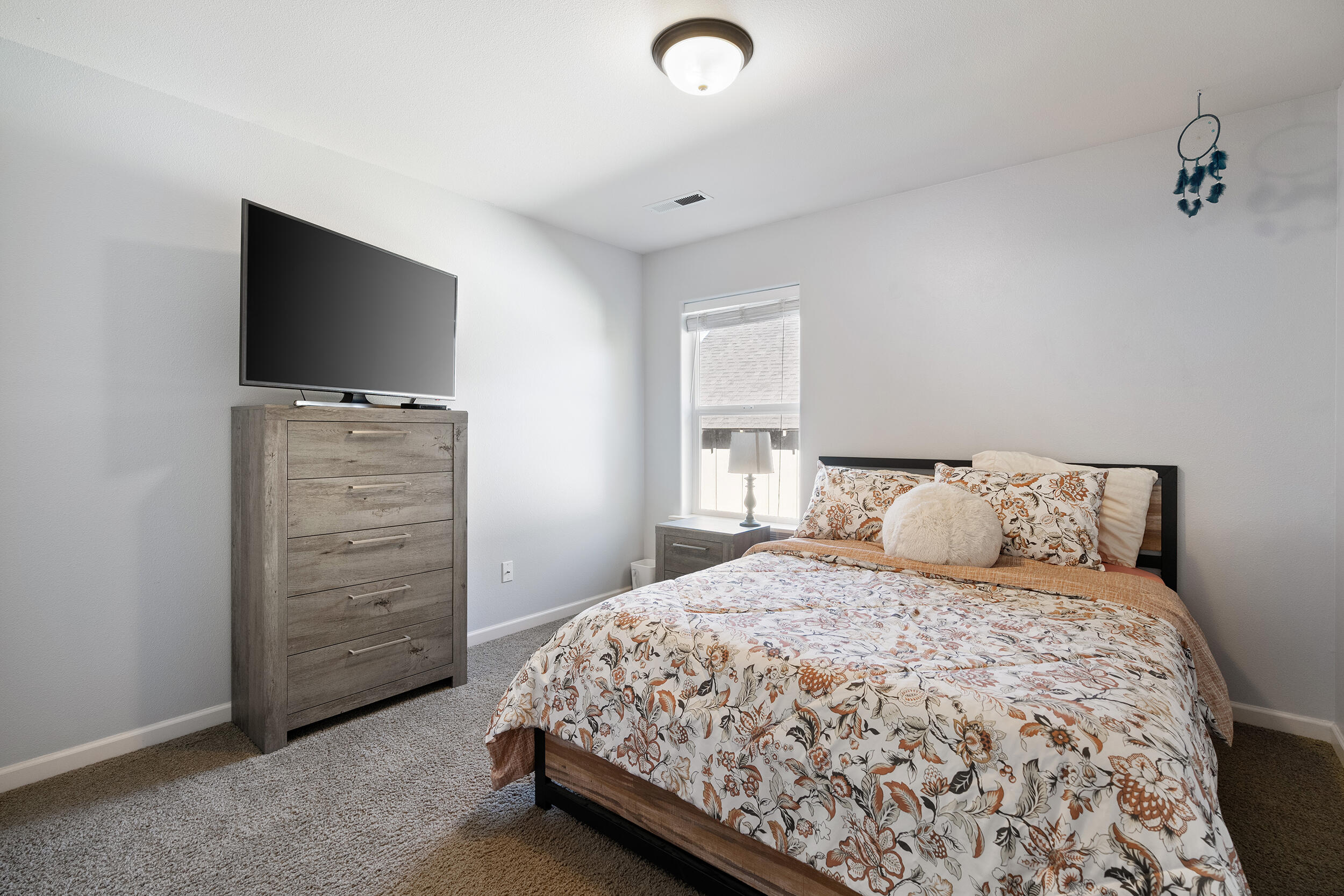 62906 Bilyeu Way Bend, OR 97701 - Photo 73 of 100 a bedroom with a bed and a flat screen tv