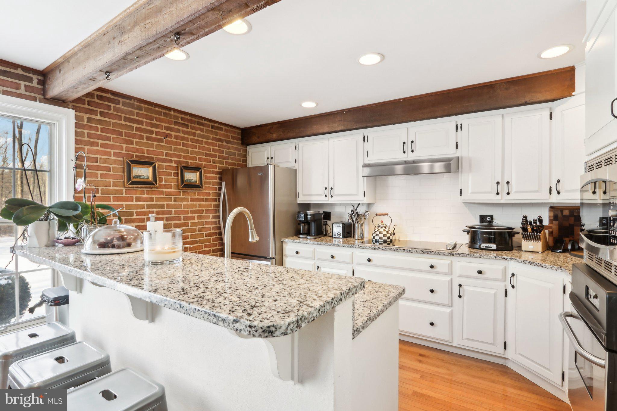 416 Dutton Mill Road Malvern, PA 19355 - Photo 13 of 56 a kitchen with granite countertop a sink a stove and cabinets